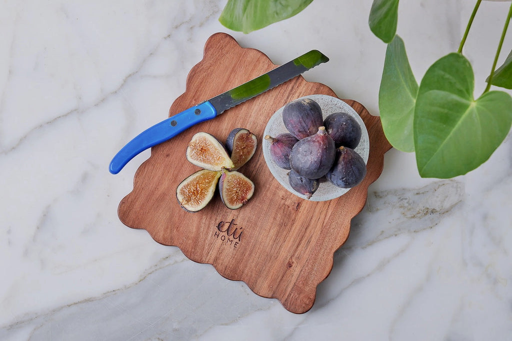 scalloped cheese board with spreader