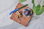 scalloped cheese board with spreader