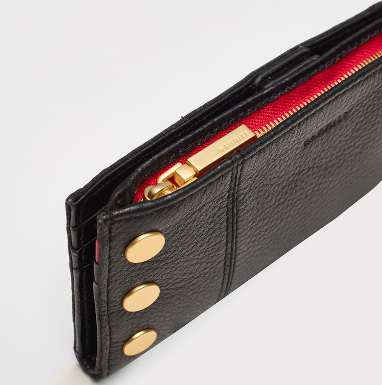 110 north in black + brushed gold with red zip